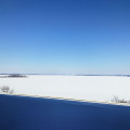 blue sky flat snow field road